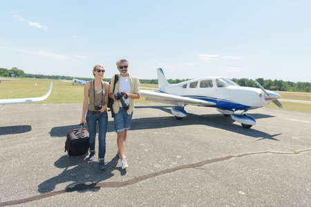 happy couple walking out of private jet