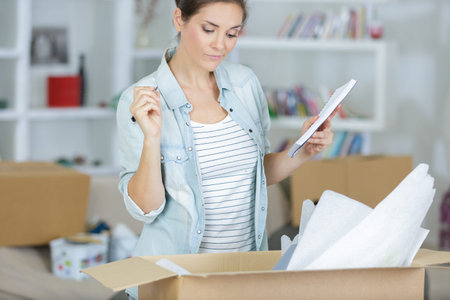 woman standing next to cardboxes