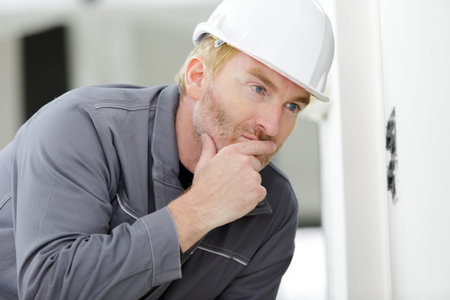 handsome builder thinking about something