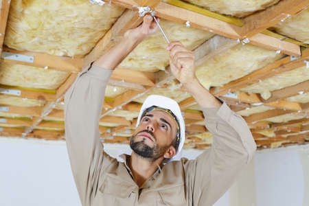 male worker on attic insulationの写真素材