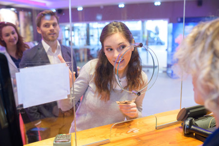 Woman buying a cinema ticketの写真素材