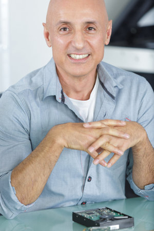 mature man happy after having fixed a hard drive