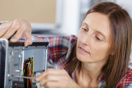 woman fixing a pc component in service centerの写真素材