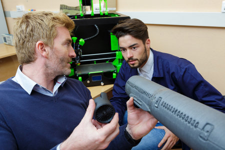 2 engineers checking a pipe indoors