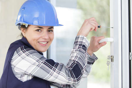 young woman builder installing windowsの写真素材