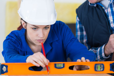 professional female worker using spirit level