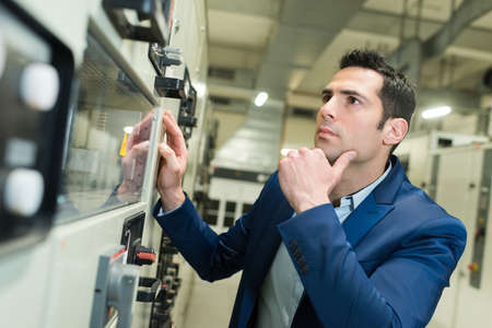 handsome guy selecting microwave oven in hypermarket and smilingの写真素材