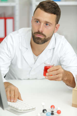 checking lab results on pcの写真素材