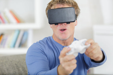 man playing with virtual reality glasses on white background