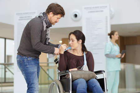 woman in wheelchair with husbandの写真素材