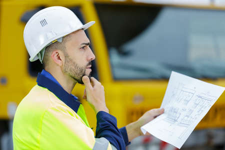 profile of pensive man in hardhatの写真素材