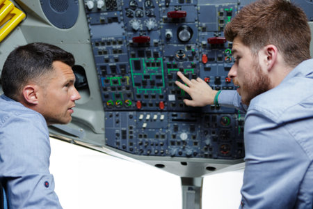 two males in the cockpit discussing about the commands