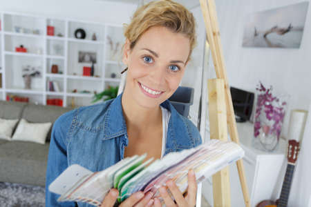 woman choice color from color swatches bookの写真素材