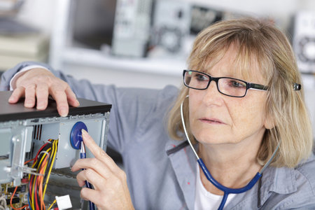 computer repair concept with woman inspecting with stethoscope