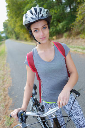 beautiful female with bicycle outdoorsの写真素材