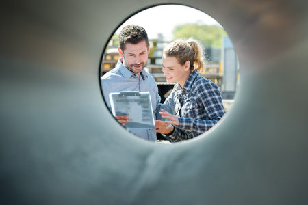man and woman being looked through a pipe