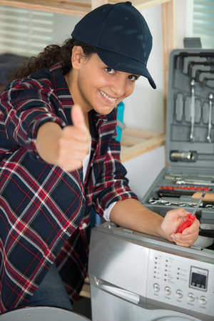 female plumber showing thumb-upの写真素材