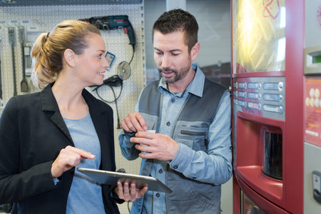 businesswoman using digital tablet with colleague