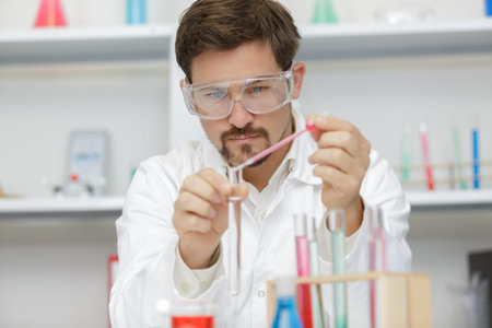 handsome student of chemistry working with chemicals