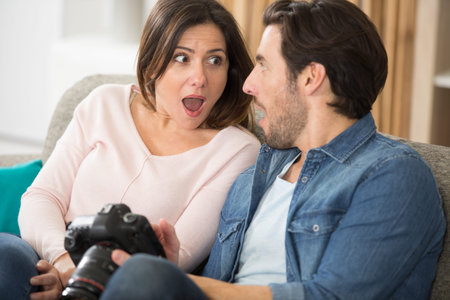 shocked couple looking at photos