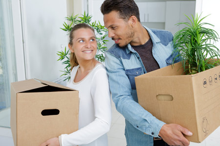 portrait of a couple moving houses