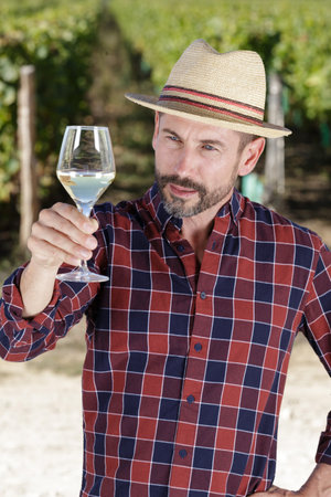 man looking before tasting white wine