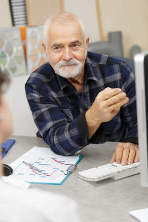 senior man using laptop in officeの写真素材