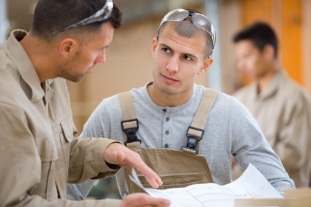 workers with paper in factory