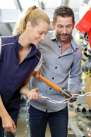 worker and customer in a large hardware storeの写真素材