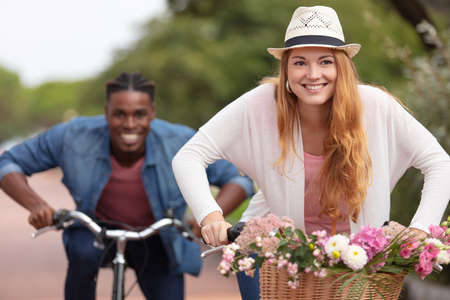 young mixed couple riding bicyclesの写真素材