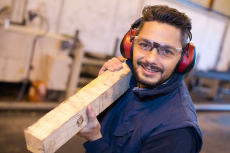 a worker is carrying plankの写真素材