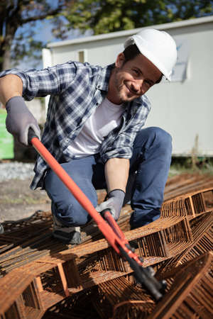 male worker using pliers at building siteの写真素材