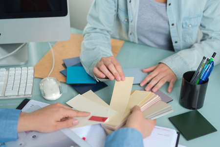 People looking through neutral paint shadesの写真素材