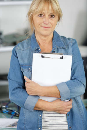 senior woman manager or supervisor with clipboardの写真素材