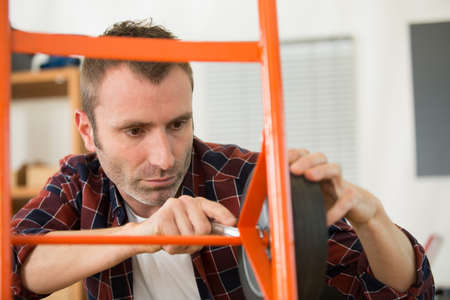 technician fixing trolley wheelの写真素材