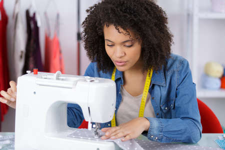 young tailor using the sewing macineの写真素材
