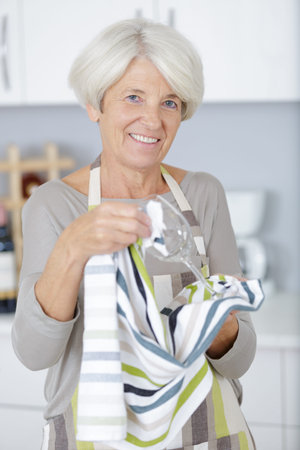 woman washes wineglasses in kitchen