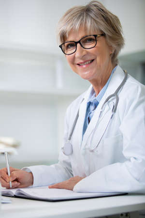 smiling medical doctor woman with stethoscopeの写真素材