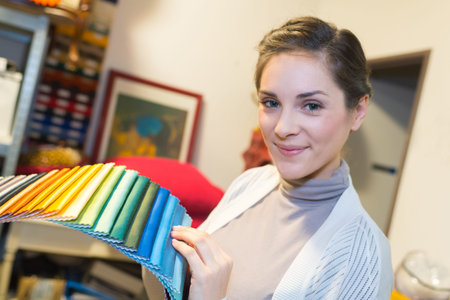 woman holding colored fabric samples