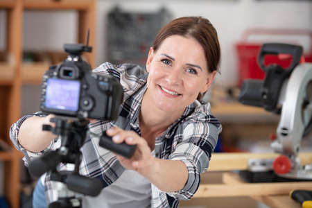 young female contractor recording video for his blogの写真素材