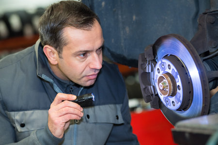 portrait of serviceman checking wheel
