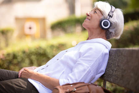 senior woman listening to some musicの写真素材