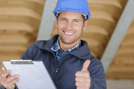happy male builder showing thumb upの写真素材