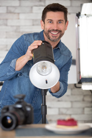 man photographing food in professional photo studio