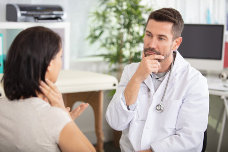 female patient being reassured by doctor in hospital room