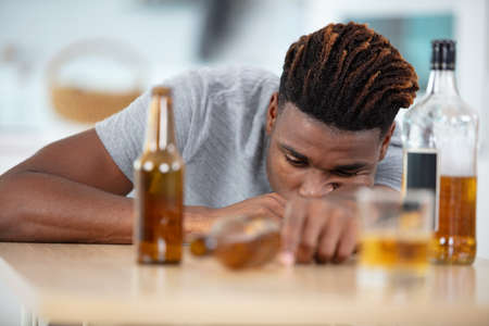 sad young man having an addiction problemの写真素材