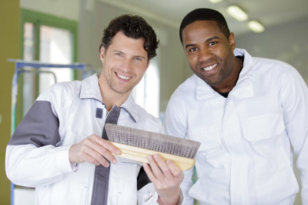 team of painters with a brush at work room