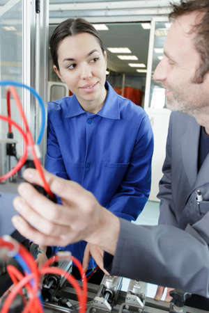 supervisor teaching female electrician apprenticeの写真素材