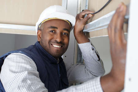 electrical technician checking electrical panel boardの写真素材
