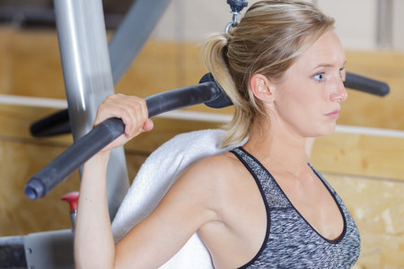 young woman doing suspension training push-ups